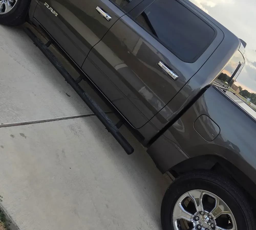 Cab, windows and side body of a gray RAM pickup.